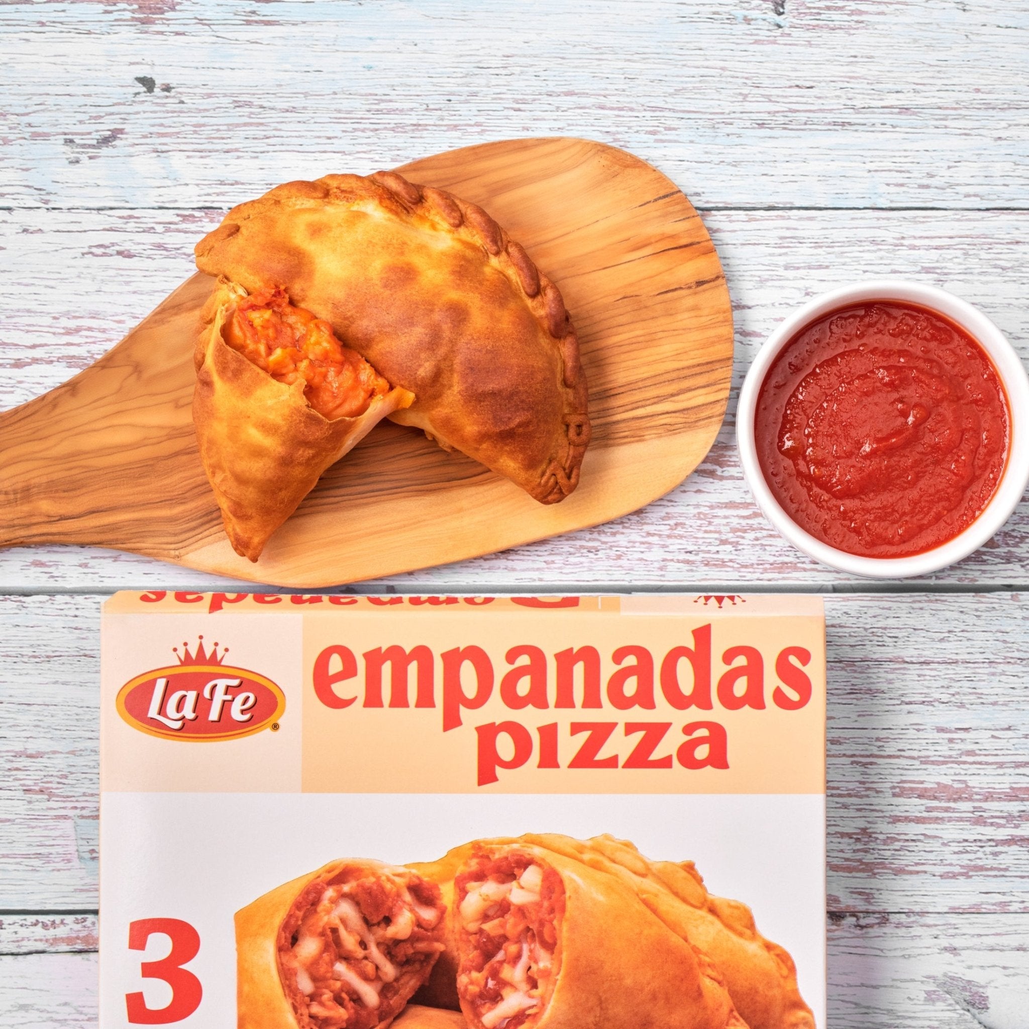 Delicious La Fe empanadas pizza served with savory dipping sauce, perfect for quick meals and authentic Latin flavors.
