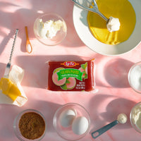 La Fe Guava Paste Clear surrounded by baking ingredients, showcasing delicious Latin flavors for snacking and baking.