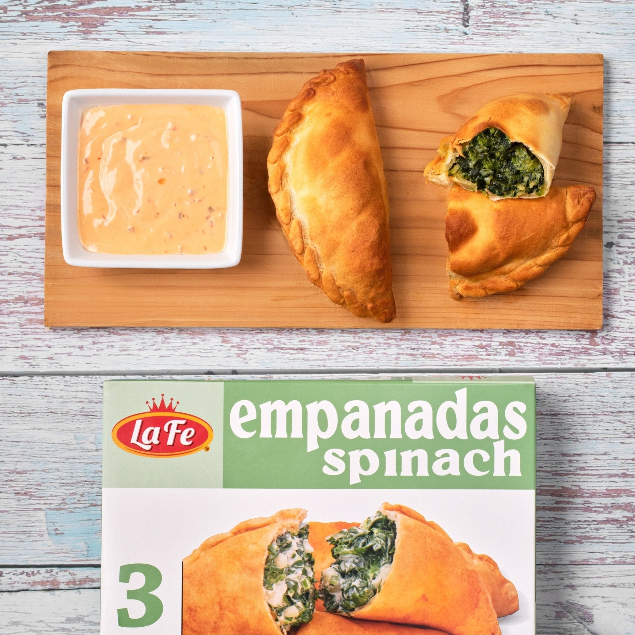 La Fe empanadas spinach served with dipping sauce, a delicious Latin frozen food option for quick meals.