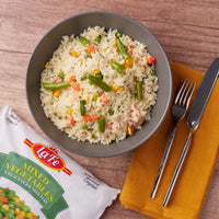 Bowl of rice with La Fe Mixed Vegetables, a delicious and nutritious blend of flavors, perfect for Latin food lovers.