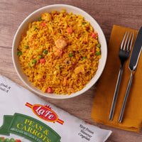 La Fe Peas & Carrots served with flavorful rice, showcasing vibrant colors and quality Latin ingredients for an authentic meal.