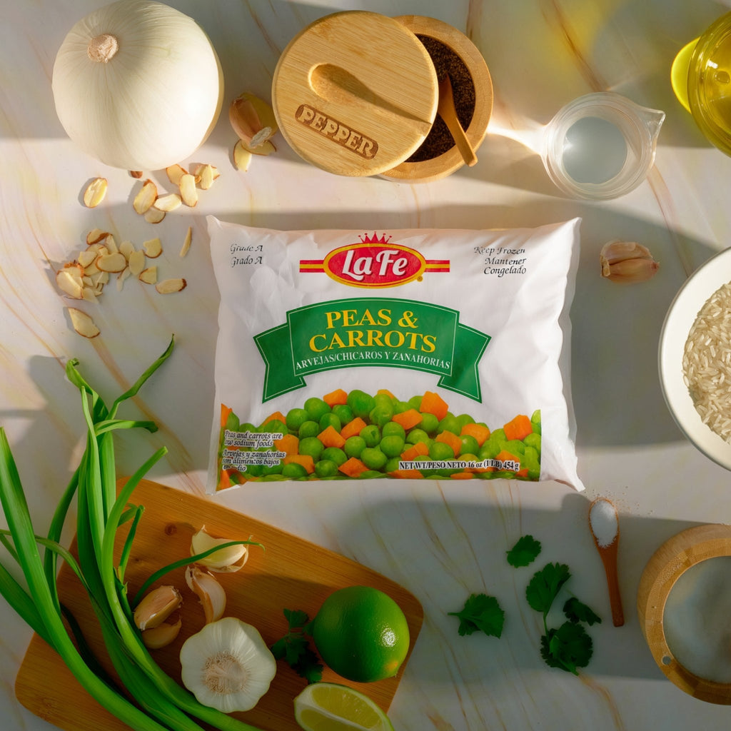 La Fe Peas & Carrots 12 oz pack with fresh vegetables on a kitchen counter, perfect for comida latina and tasty meals.