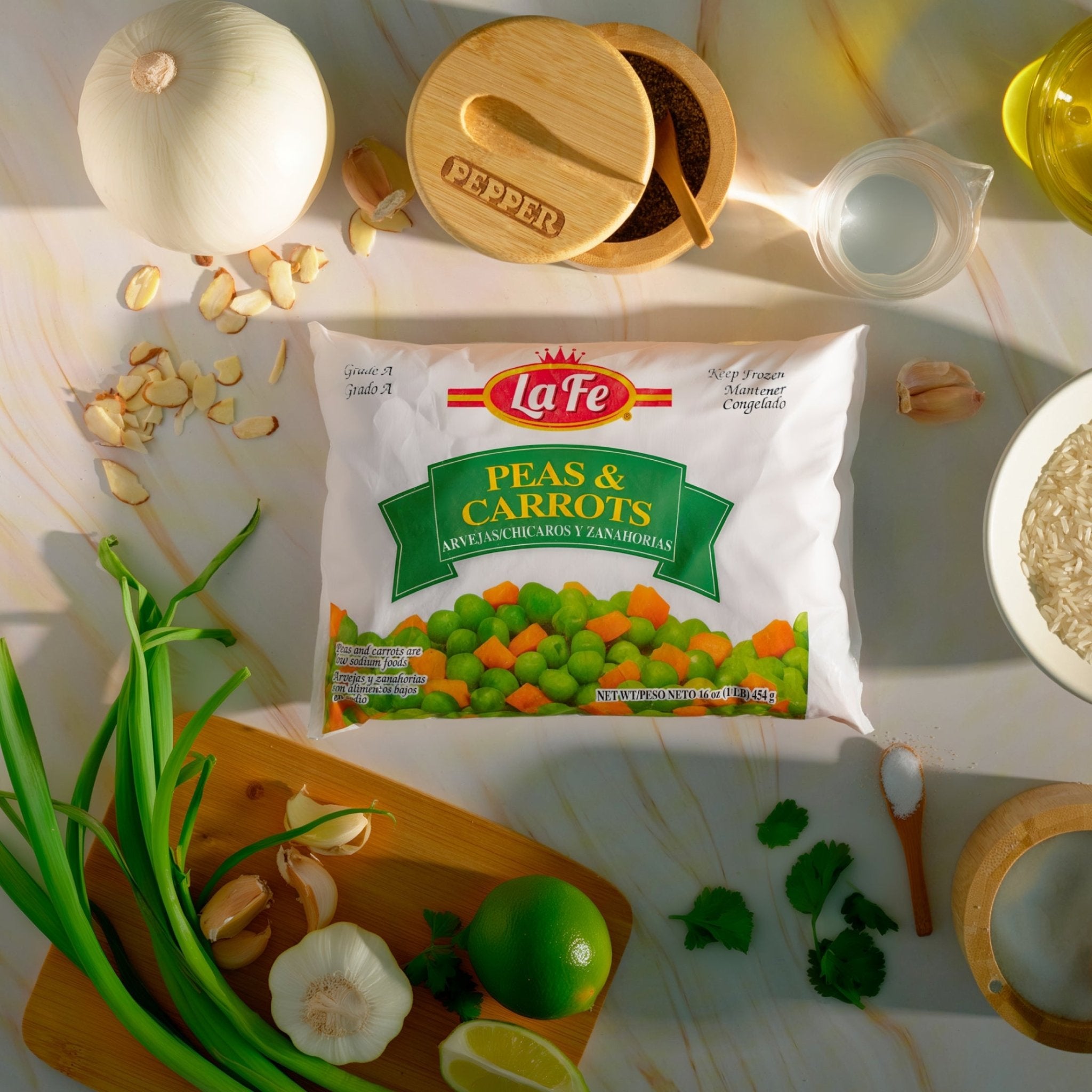 La Fe Peas & Carrots 12 oz pack with fresh vegetables on a kitchen counter, perfect for comida latina and tasty meals.