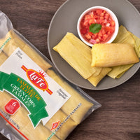 Delicious LAFE Green Corn Tamales served with fresh salsa, perfect for enjoying authentic Latin flavors.