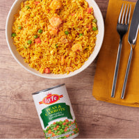 La Fe Peas & Carrots can next to a bowl of flavorful yellow rice with shrimp, perfect for quick, nutritious meal prep.