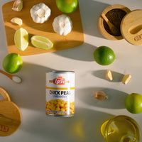 LA FE Chick Peas surrounded by garlic, lime, and spices for authentic Latin flavors in your meals.