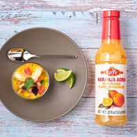 La Fe Naranja Agria sour orange marinade with fresh seafood ceviche and lime, perfect for authentic Latin flavors.