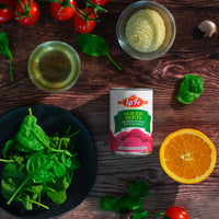 La Fe sliced beets can surrounded by fresh ingredients like spinach, cherry tomatoes, and orange for healthy Latin meals.