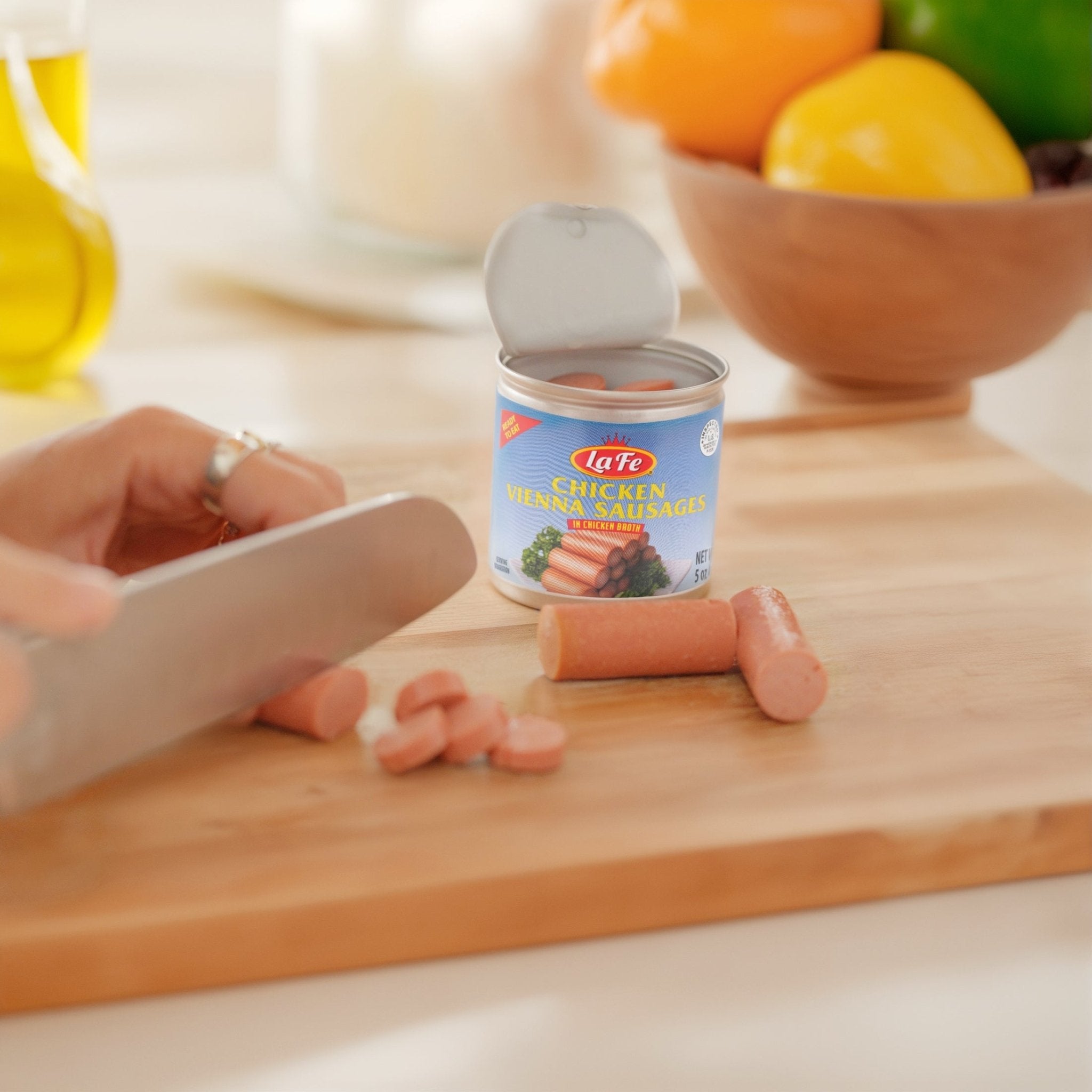 La Fe Chicken Vienna Sausages in a can, sliced on a cutting board, showcasing quality Latin food for delicious meals.