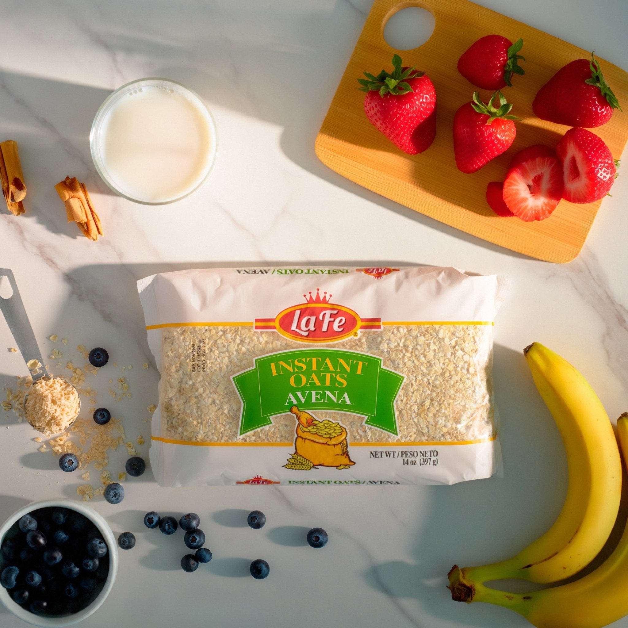 LA FE Quick Oats bag with fresh strawberries, blueberries, milk, and bananas, perfect for a nutritious Latin breakfast.