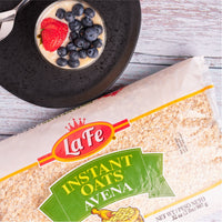 La Fe Quick Oats package with a bowl of oatmeal topped with fresh strawberries and blueberries, perfect for a nutritious breakfast.