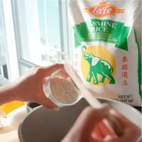 La Fe Jasmine Rice pack with hands pouring rice into a bowl, representing quality Latin food for delicious meals.