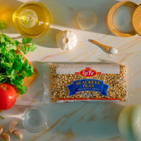 LA FE Dry Blackeye Peas on a kitchen counter with ingredients for authentic Latin food, perfect for nutritious meals.