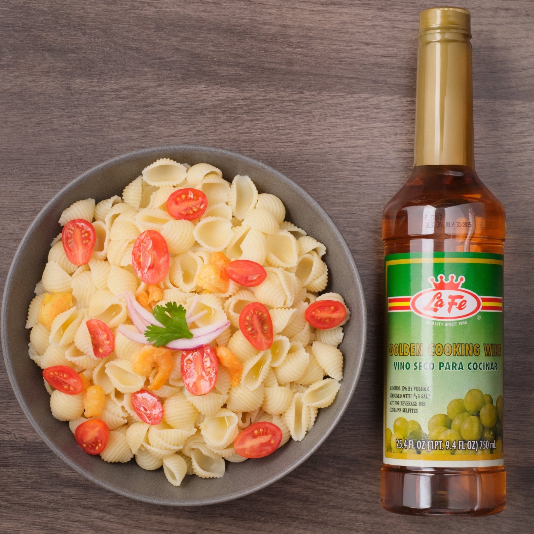 Bowl of pasta with tomatoes and LAFE Golden Cooking Wine on the side, perfect for enhancing Latin flavors in dishes.