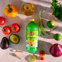 La Fe Lemon Juice bottle surrounded by fresh vegetables, enhancing authentic Latin flavors for your dishes.