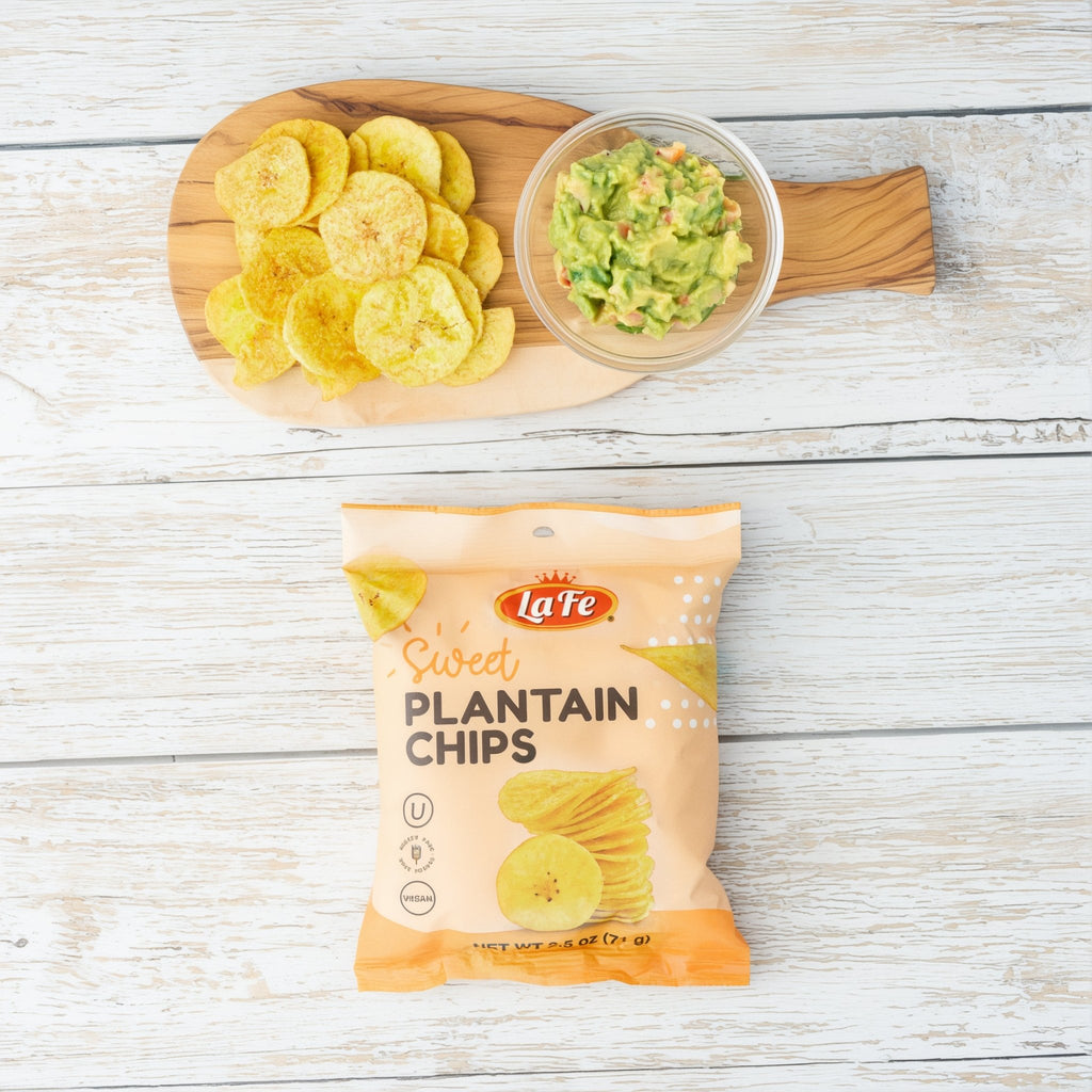La Fe Sweet Plantain Chips snack with guacamole on a wooden board, perfect for enjoying authentic Latin flavors.