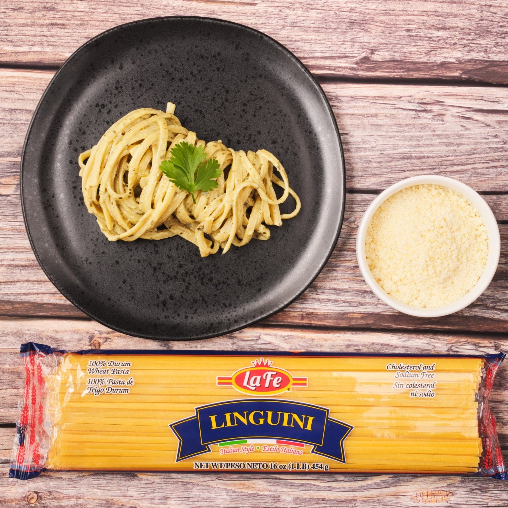Delicious La Fe Linguini served with pesto, alongside grated cheese, perfect for authentic Latin flavors.