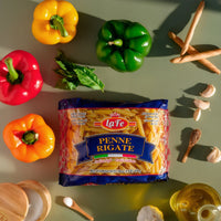 La Fe Pasta Penne Rigate package surrounded by fresh vegetables and ingredients, perfect for authentic Latin cooking.