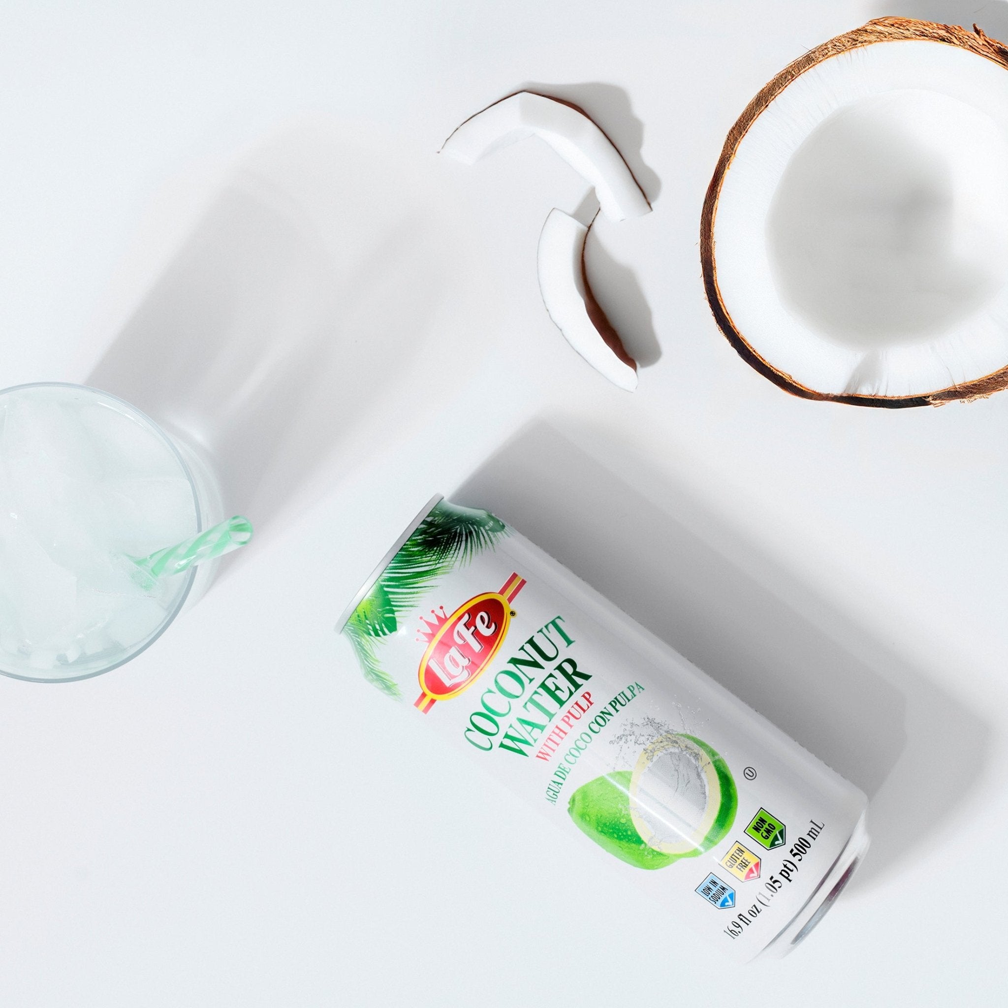 LA FE Drink Coconut Water can with a coconut half and a refreshing glass, perfect for healthy hydration.