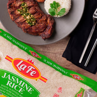 La Fe Jasmine Rice paired with grilled steak and rice, showcasing authentic Latin flavors for a quality meal.
