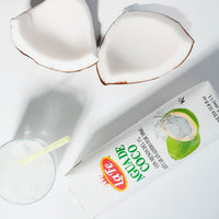 La Fe coconut water packaging with fresh coconut halves, a refreshing choice for tropical flavors and quality Latin drinks.