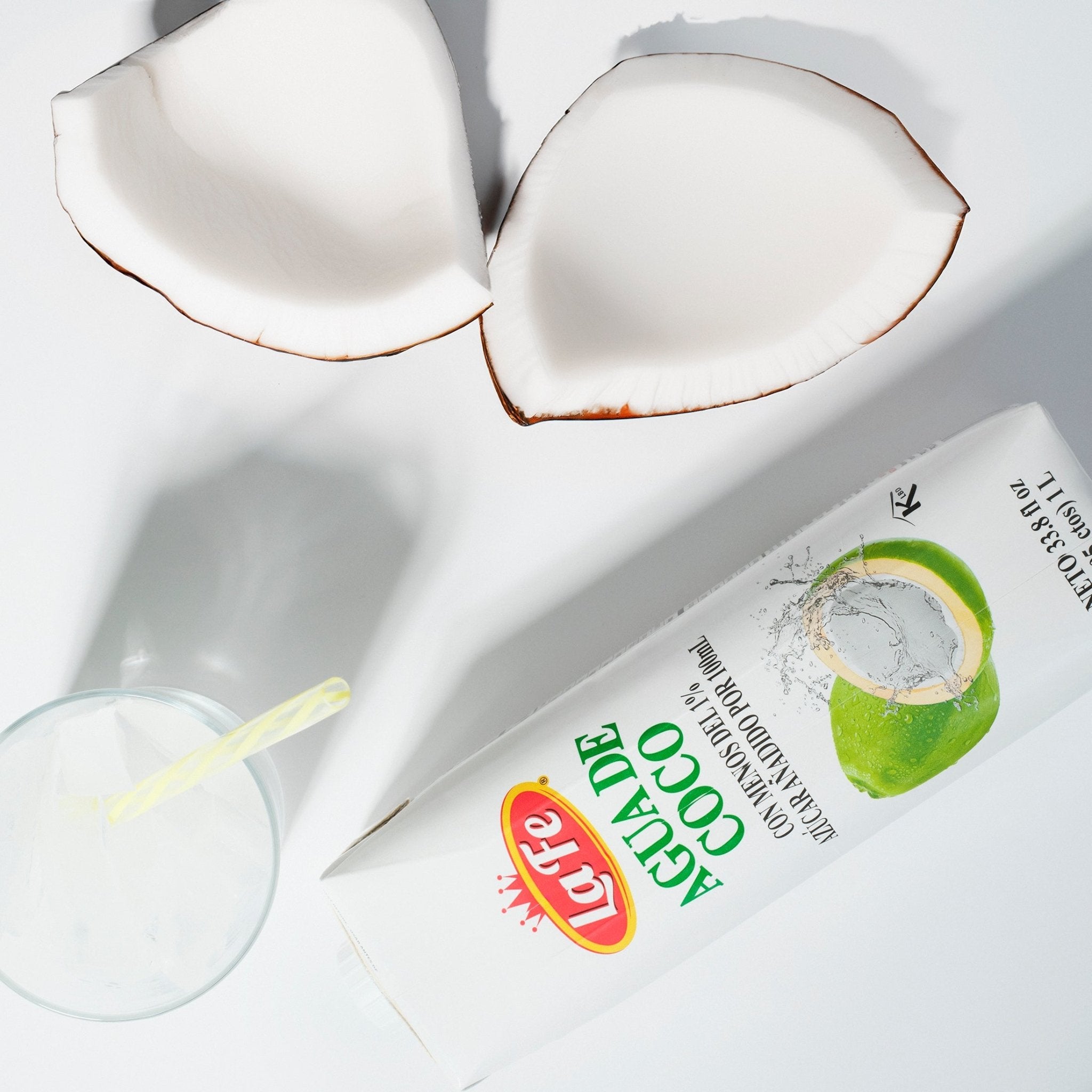 La Fe coconut water packaging with fresh coconut halves, a refreshing choice for tropical flavors and quality Latin drinks.