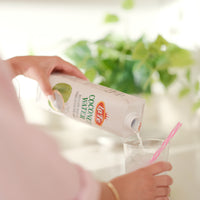 Pouring La Fe Prisma Coconut Water into a glass, a refreshing, sugar-free drink choice for quality hydration.